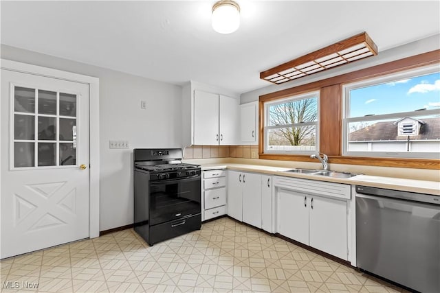 kitchen with dishwasher, white cabinets, black range with gas cooktop, and a sink