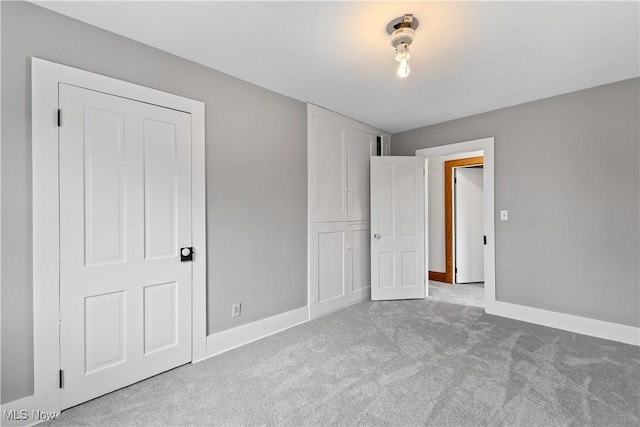 unfurnished bedroom with carpet and baseboards