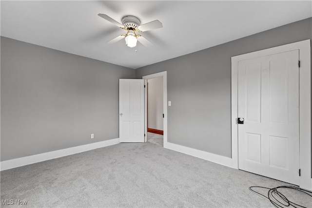 unfurnished bedroom with carpet flooring, a ceiling fan, and baseboards