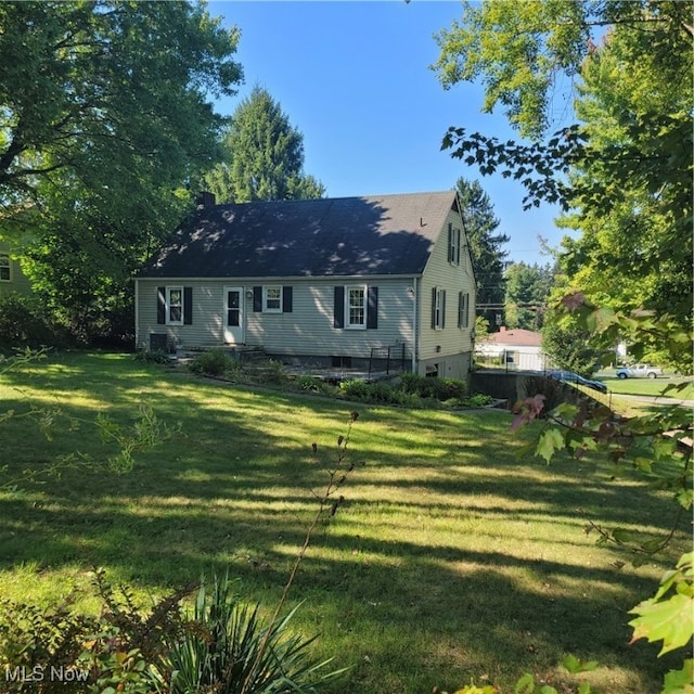 rear view of house with a lawn