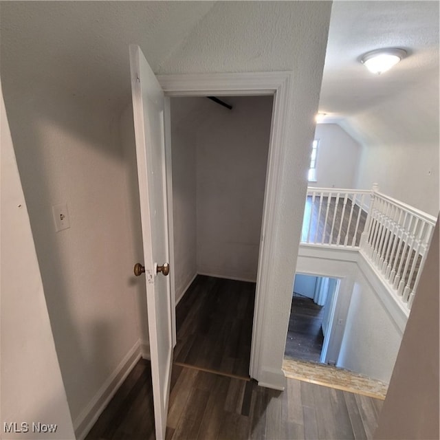 stairs with wood-type flooring and lofted ceiling