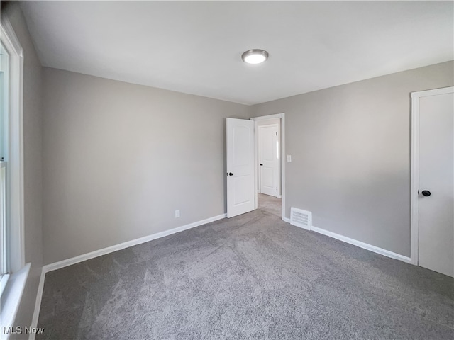 unfurnished room featuring carpet