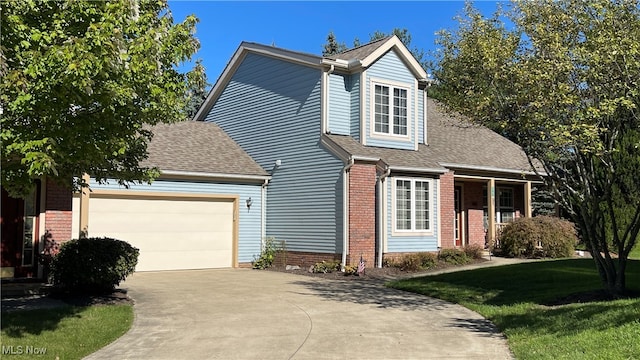 view of front facade with a front yard and a garage