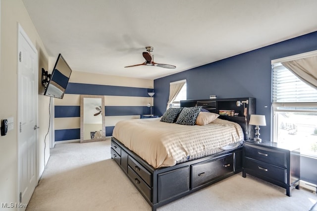 bedroom featuring ceiling fan and light carpet