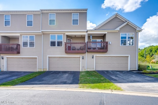 townhome / multi-family property with a balcony and a garage