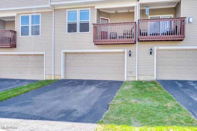 townhome / multi-family property featuring a balcony and a garage