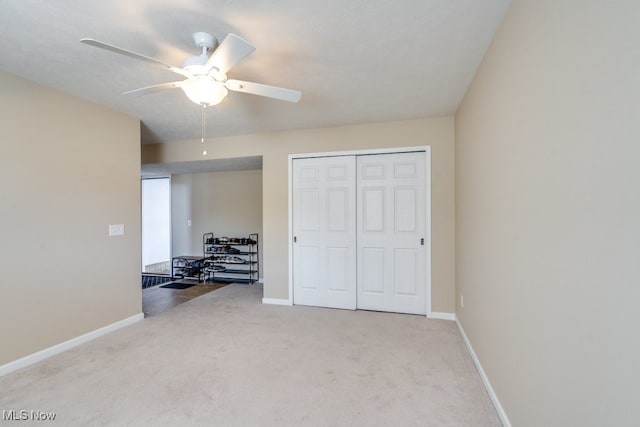 bedroom featuring a closet, ceiling fan, light colored carpet, and a textured ceiling