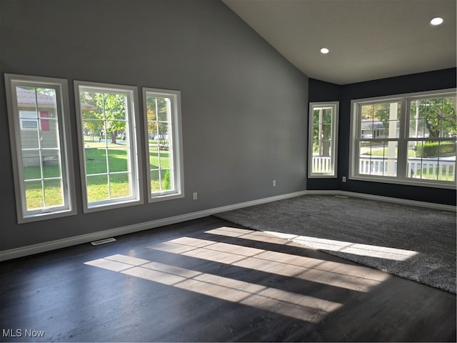 empty room featuring dark hardwood / wood-style flooring and high vaulted ceiling