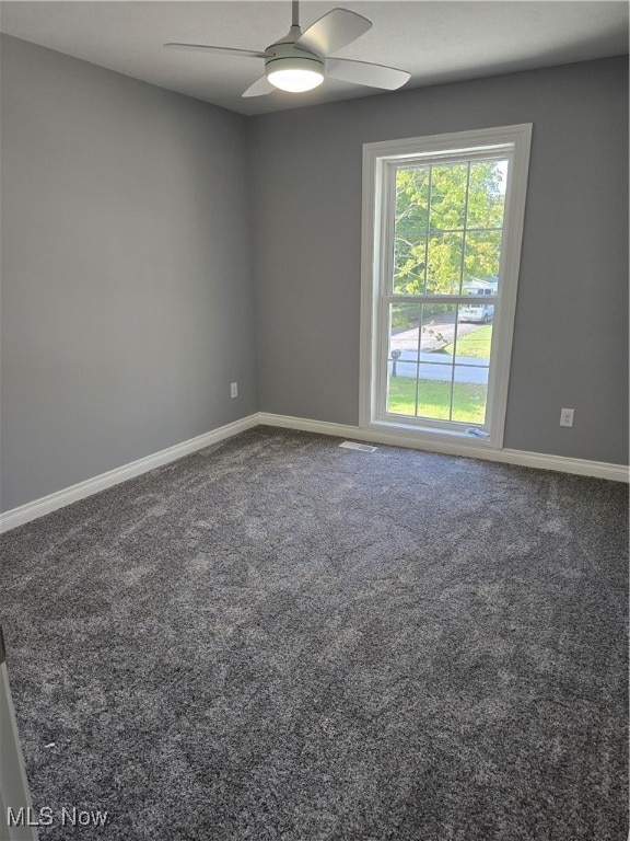 carpeted empty room featuring ceiling fan