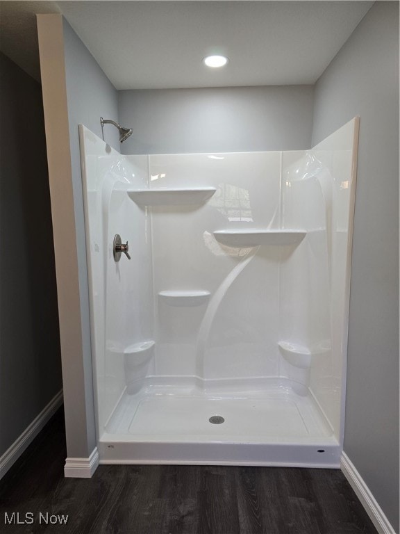 bathroom featuring wood-type flooring and walk in shower