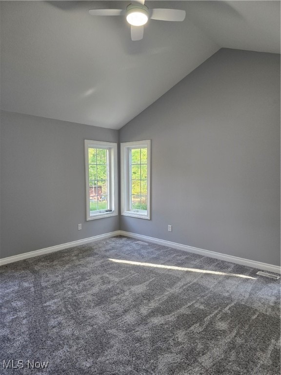 spare room with carpet, vaulted ceiling, and ceiling fan