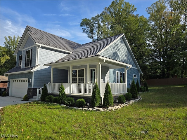 exterior space with a yard, a garage, and a porch