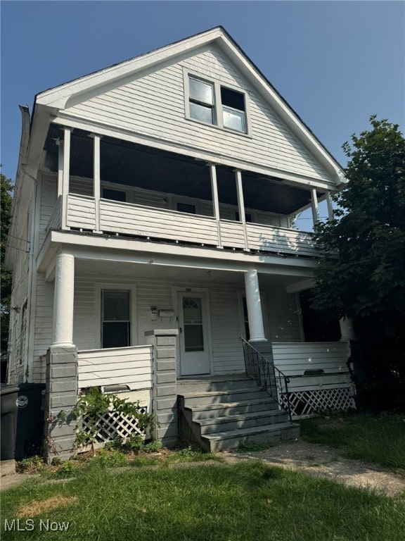 view of front of home featuring a balcony and a porch