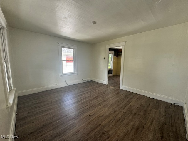 unfurnished room featuring dark hardwood / wood-style floors