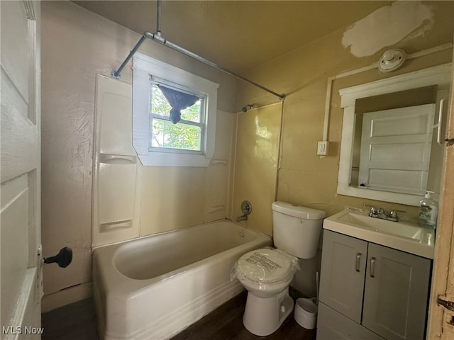 full bathroom with washtub / shower combination, hardwood / wood-style floors, vanity, and toilet