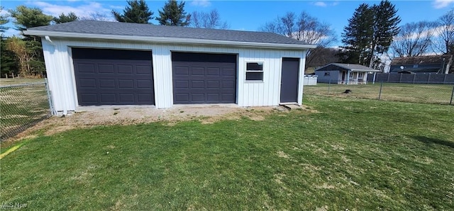 garage featuring a lawn