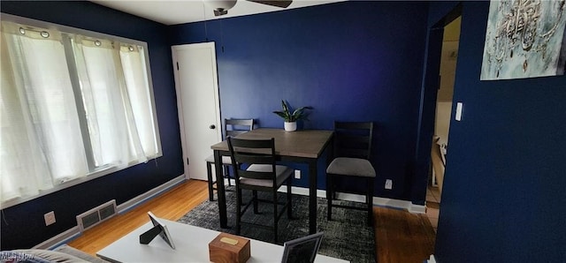 dining space featuring ceiling fan and hardwood / wood-style floors