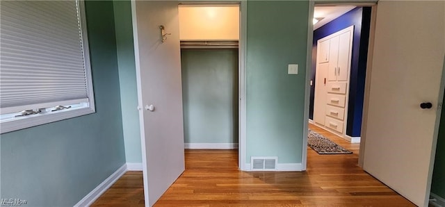 unfurnished bedroom featuring wood-type flooring and a closet