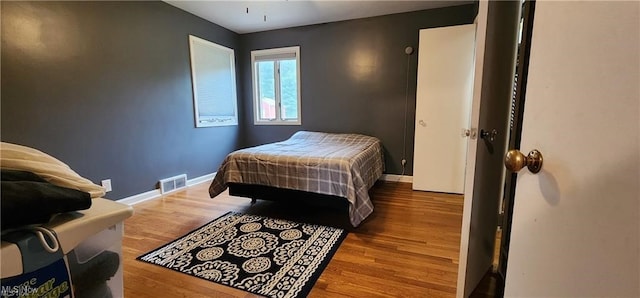 bedroom with hardwood / wood-style floors