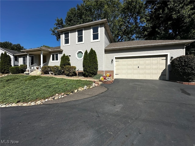 view of front of house featuring a front yard and a garage