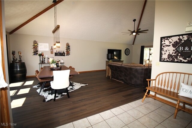 dining room with light wood-type flooring, vaulted ceiling with beams, and ceiling fan