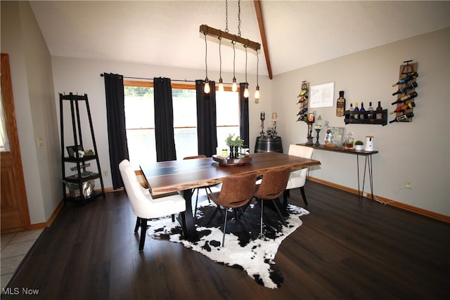 dining space featuring vaulted ceiling and dark hardwood / wood-style floors