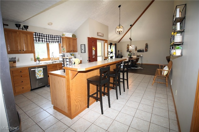 kitchen with hanging light fixtures, stainless steel dishwasher, a center island, a breakfast bar area, and vaulted ceiling