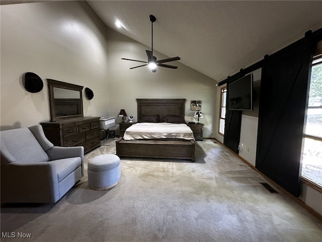 carpeted bedroom featuring high vaulted ceiling, multiple windows, ceiling fan, and a barn door