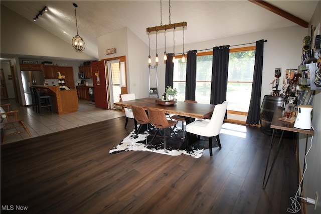 dining area featuring wood-type flooring and high vaulted ceiling