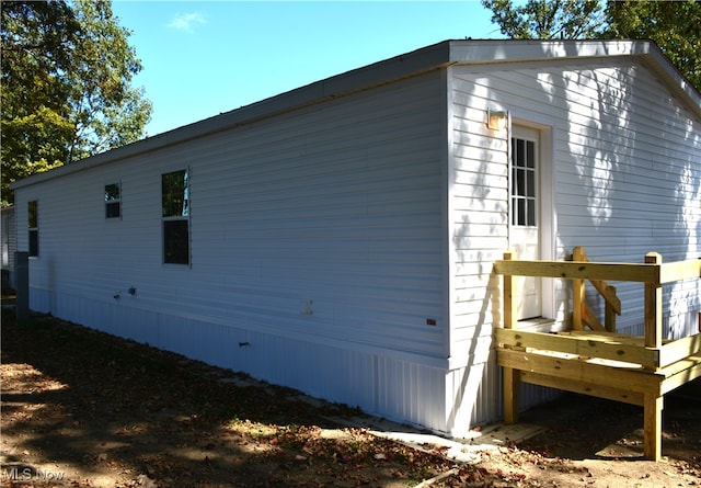 view of property exterior with a wooden deck