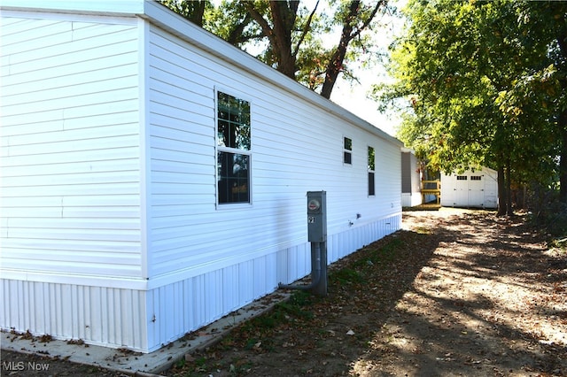 view of side of property with a storage unit