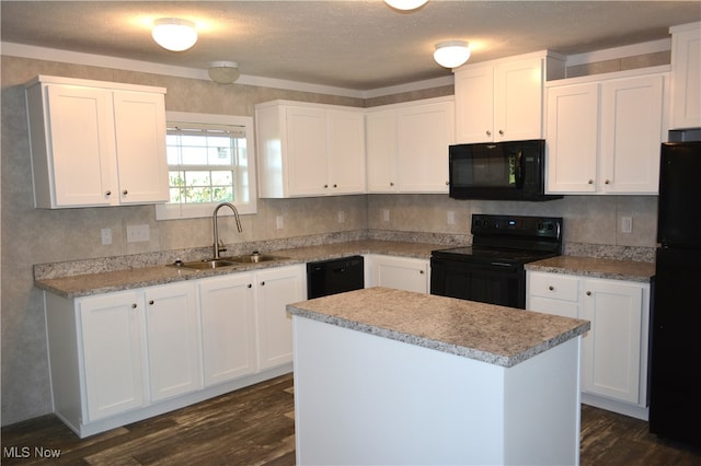 kitchen featuring black appliances, white cabinetry, and sink