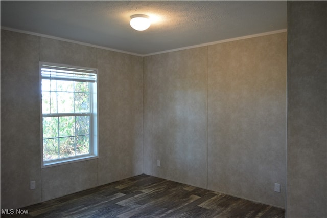 empty room featuring ornamental molding, a textured ceiling, and dark hardwood / wood-style flooring