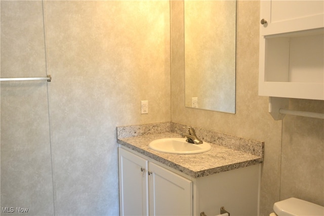 bathroom with vanity and toilet