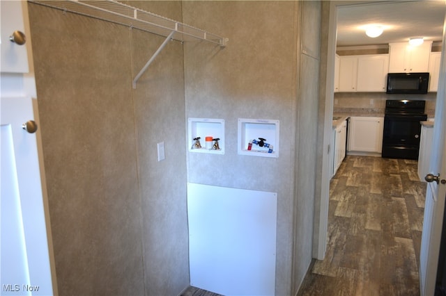 interior space with hookup for a washing machine, dark hardwood / wood-style flooring, and cabinets