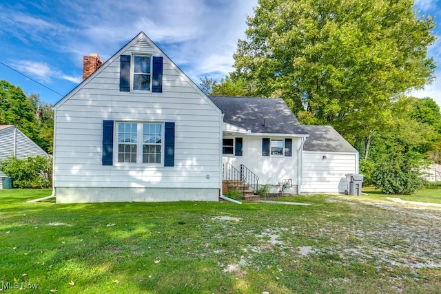 back of house with a lawn