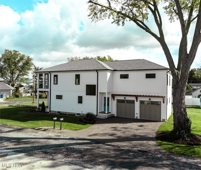 view of front of house featuring a garage and a front lawn