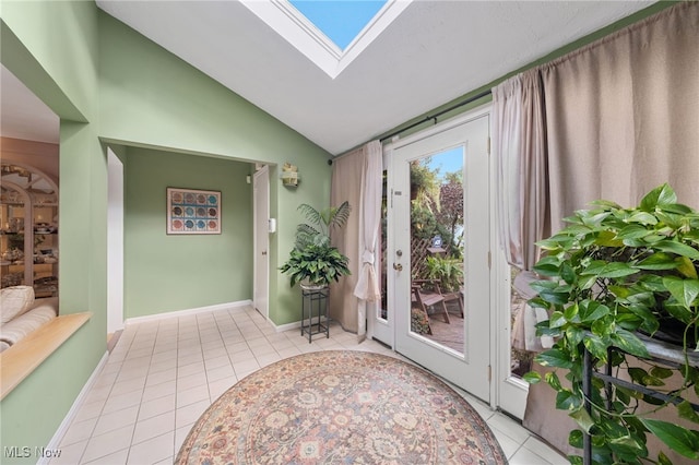 doorway with lofted ceiling with skylight and light tile patterned floors