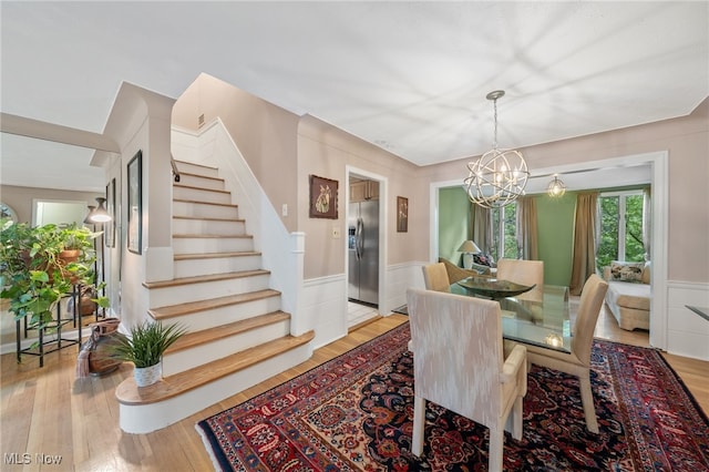 dining area with a chandelier and light hardwood / wood-style floors