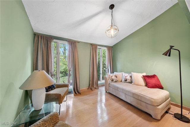 living room with lofted ceiling and light wood-type flooring