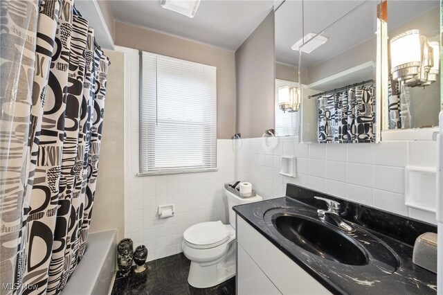 full bathroom with vanity, toilet, tile walls, and shower / tub combo with curtain