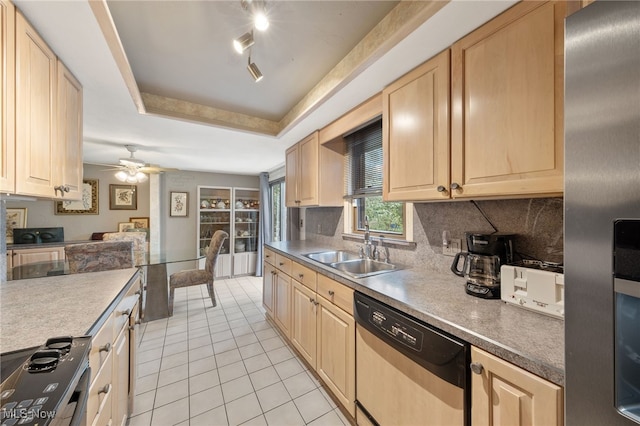 kitchen featuring light brown cabinetry, sink, a tray ceiling, and appliances with stainless steel finishes