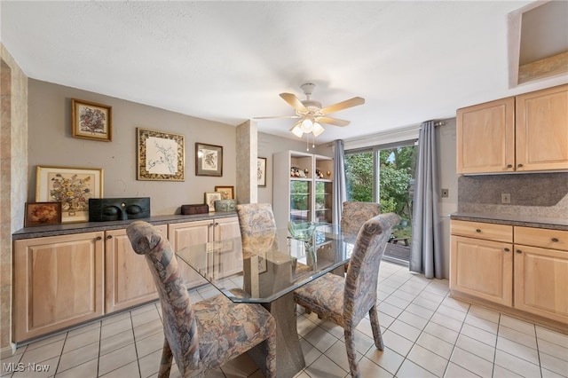 tiled dining space featuring ceiling fan