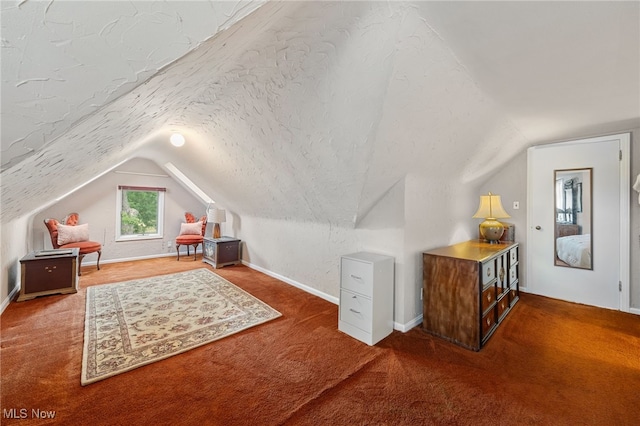 additional living space with carpet flooring, vaulted ceiling, and a textured ceiling