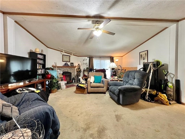 carpeted living room featuring a textured ceiling, a fireplace, vaulted ceiling with beams, crown molding, and ceiling fan