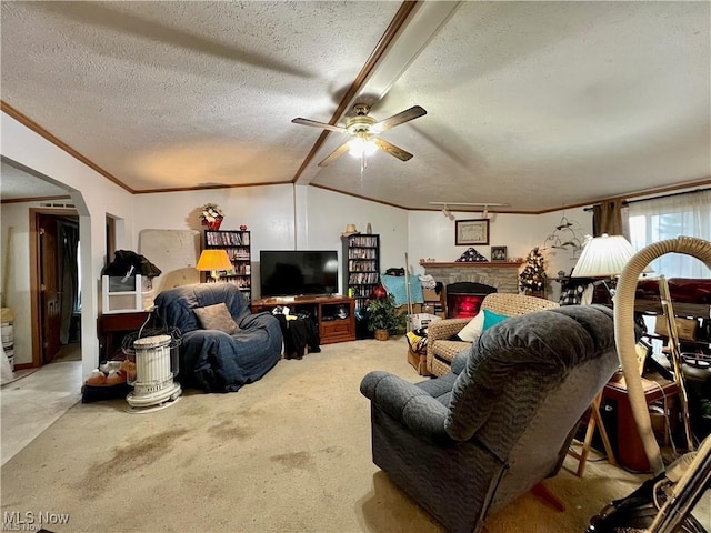 living room with ceiling fan, carpet floors, a fireplace, and a textured ceiling