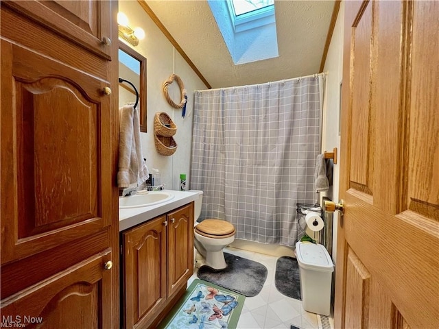 bathroom featuring vanity, a skylight, curtained shower, tile patterned floors, and toilet