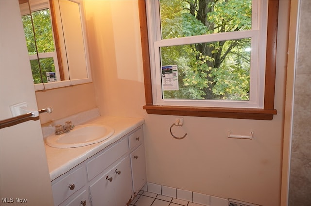 bathroom featuring tile patterned flooring, vanity, and plenty of natural light