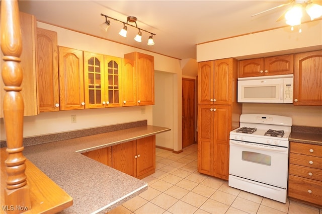 kitchen with white appliances, ceiling fan, and light tile patterned flooring