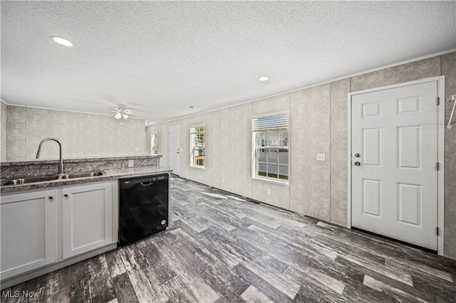 kitchen featuring white cabinets, black dishwasher, wood-type flooring, ceiling fan, and sink